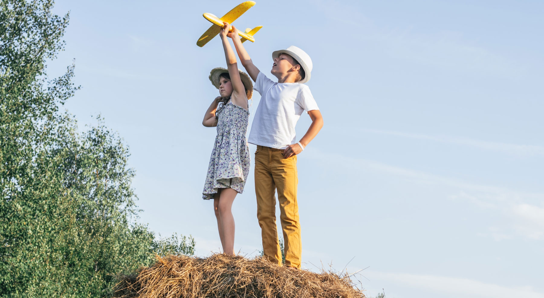 59508839-little-girl-and-boy-together-launch-yellow-toy-airplane.jpg