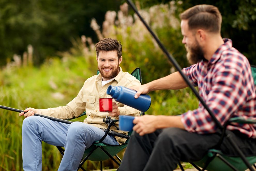 mp30729031-friends-fishing-and-drinking-tea-from-thermos.jpg